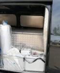 02_View through the van’s side door showing the equipment for undertakers