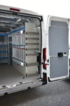 03_The right of the Ducato with custom-made shelving and plastic jerry cans for the travelling trader