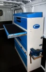 A drawer with a built-in writing board in a plumber’s van