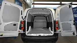 A marble-look plywood floor liner and interior liners in an Opel Combo