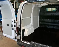 A plywood floor liner and steel sheet bodywork liners in the NV200