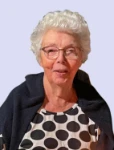 A smiling Maria posing for an official photo 