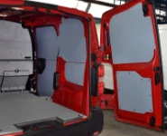 Plywood floor and bulkhead liners and plastic bodywork liners on the right of the Vivaro