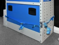 Racking system with straps in floor-level compartments