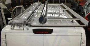 04_A 2022 Opel Movano with a ladder slide, a cylindrical pipe carrier and a rear loading roller