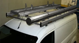 Van with tube carrier and ladder rack for antenna specialists